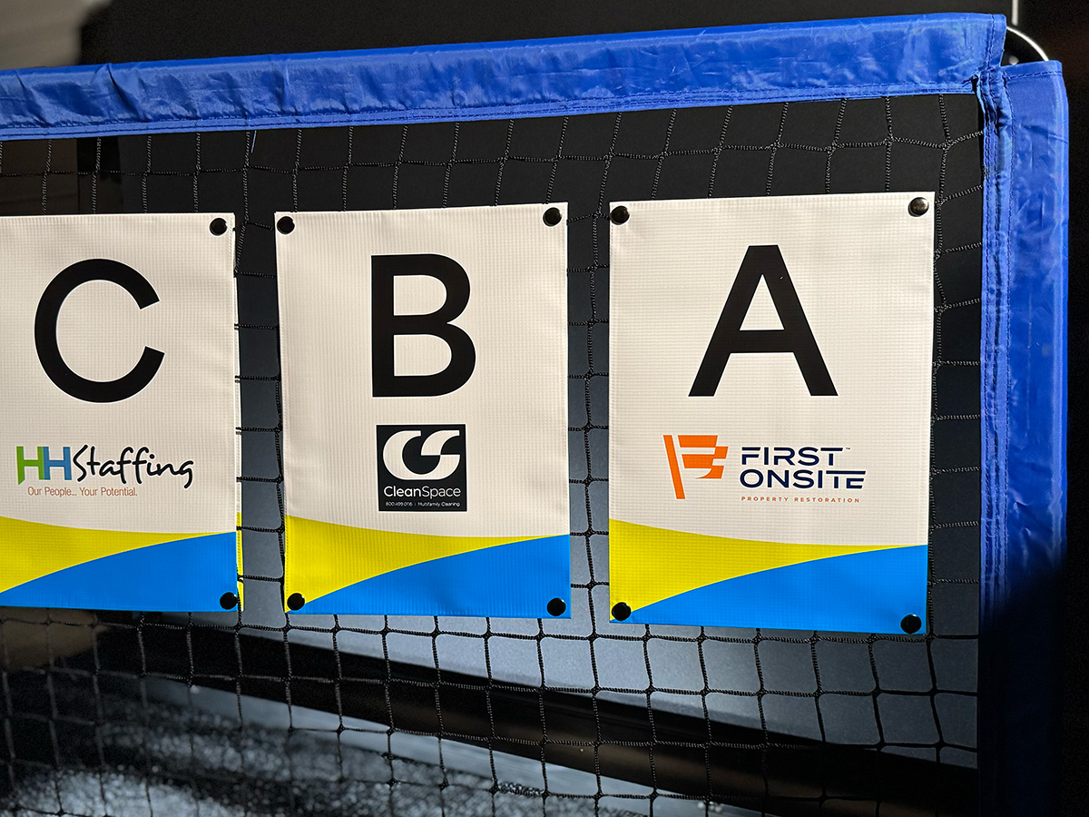 Multi-sponsor NetSnaps banners displayed across a full volleyball tournament setup